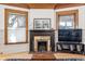 Cozy living room with a decorative fireplace, wood trim, and two large windows for plenty of light at 1401 N Franklin St # 1, Denver, CO 80218