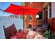 Cozy patio with outdoor seating, red umbrella, barbecue grill, and well-maintained fencing at 1401 N Franklin St # 1, Denver, CO 80218
