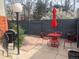 Cozy patio area with red table, chairs, umbrella, and black grill, perfect for outdoor dining and relaxation at 1401 N Franklin St # 1, Denver, CO 80218