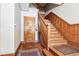 Classic wooden staircase with detailed banister and a small rug at the bottom at 1401 N Franklin St # 1, Denver, CO 80218
