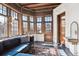 Bright sunroom features many windows, wood trim, and comfortable seating at 1401 N Franklin St # 1, Denver, CO 80218