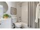 Cozy bathroom featuring a shower over tub, complemented by a decorative wall art and modern sink at 2642 Devonshire Ct, Denver, CO 80229