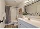 Bathroom featuring a shower-tub combo, sleek vanity, and modern fixtures at 2642 Devonshire Ct, Denver, CO 80229