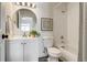 Bathroom featuring a bathtub, vanity, and circular mirror at 2642 Devonshire Ct, Denver, CO 80229