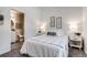 Bright bedroom featuring neutral decor, ensuite bathroom, and carpeted floors at 2642 Devonshire Ct, Denver, CO 80229