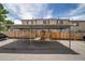 Carport in front of townhomes with wood fence and space for multiple vehicles at 2642 Devonshire Ct, Denver, CO 80229