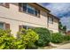 Charming townhome with neat landscaping under a blue sky providing an inviting curb appeal at 2642 Devonshire Ct, Denver, CO 80229