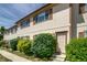 Inviting townhome exterior with a well-maintained lawn and lush landscaping, providing curb appeal at 2642 Devonshire Ct, Denver, CO 80229