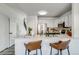 Kitchen with a breakfast bar, stainless steel appliances, and a staircase view at 2642 Devonshire Ct, Denver, CO 80229