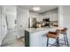 Contemporary kitchen featuring a breakfast bar with seating and stainless steel appliances at 2642 Devonshire Ct, Denver, CO 80229