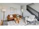 Stylish living room featuring modern decor, comfortable sofa, staircase and convenient half bathroom access at 2642 Devonshire Ct, Denver, CO 80229