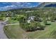 Stunning aerial view of home nestled in a community of homes and large trees at 18376 Heavens Pl, Monument, CO 80132