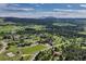 Expansive aerial shot displaying homes surrounded by lush green trees and mountain views at 18376 Heavens Pl, Monument, CO 80132