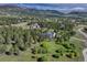 Expansive aerial view of a home nestled among trees with mountain views at 18376 Heavens Pl, Monument, CO 80132