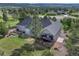 Aerial view of home with a backyard featuring a patio and lush landscaping at 18376 Heavens Pl, Monument, CO 80132