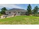 Large backyard with mature trees, lush lawn, a deck, and trampoline at 18376 Heavens Pl, Monument, CO 80132