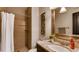 Well-lit bathroom featuring a tiled shower, framed mirror and marble vanity at 18376 Heavens Pl, Monument, CO 80132