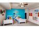 Bright bedroom with twin beds, colorful decor, and ample storage space at 18376 Heavens Pl, Monument, CO 80132