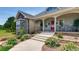 Lovely home entrance with stone accents, landscaped garden beds, and a welcoming front porch at 18376 Heavens Pl, Monument, CO 80132