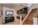 Inviting entryway with piano, built-in storage, and staircase leading to the upper level at 18376 Heavens Pl, Monument, CO 80132