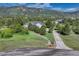 View of a well kept home nestled on a lot with mature trees and paved drive at 18376 Heavens Pl, Monument, CO 80132