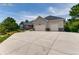 Charming single-story home featuring a three-car garage and a wide driveway on a sunny day at 18376 Heavens Pl, Monument, CO 80132