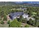 Aerial view of a gray home with a red door and a spacious three-car driveway at 18376 Heavens Pl, Monument, CO 80132