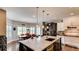 Open-concept kitchen features a large island, granite counters, and stainless steel appliances at 18376 Heavens Pl, Monument, CO 80132