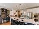 Modern kitchen boasts a large center island, stainless steel appliances, and pendant lighting at 18376 Heavens Pl, Monument, CO 80132