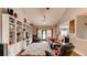 Spacious living room featuring a large built-in shelving unit, with comfortable seating and lots of light at 18376 Heavens Pl, Monument, CO 80132