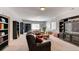 Spacious living room with comfortable seating, built-in bookshelves, and ample natural light at 18376 Heavens Pl, Monument, CO 80132