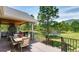 Inviting outdoor patio featuring a stone fireplace and views of the lush green surroundings at 18376 Heavens Pl, Monument, CO 80132