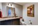 Cozy powder room featuring a granite countertop, framed mirror, and artwork on the wall at 18376 Heavens Pl, Monument, CO 80132