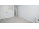 Spacious bedroom with neutral carpet, built-in shelves and a pristine white door at 2203 S Holly St # 3, Denver, CO 80222