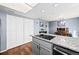 Kitchen island with granite countertops and a black cooktop at 12564 W Virginia Ave, Lakewood, CO 80228