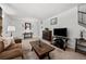 Spacious living room featuring a comfortable sofa and flat-screen TV at 12564 W Virginia Ave, Lakewood, CO 80228