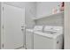 Laundry room with washer, dryer, and storage shelf at 971 Parsons Ave, Castle Rock, CO 80104