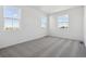 Bright bedroom with grey carpet and two large windows at 6585 N Nepal St, Aurora, CO 80019