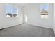 Well-lit bedroom with carpet and two windows at 6585 N Nepal St, Aurora, CO 80019