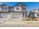 Two-story home with gray siding, white trim, and a two-car garage at 6585 N Nepal St, Aurora, CO 80019