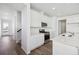 Modern kitchen with white cabinets, stainless steel appliances, and quartz countertops at 6585 N Nepal St, Aurora, CO 80019