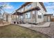 Spacious backyard with a deck and walkway leading to the house at 13676 Cherry Way, Thornton, CO 80602