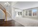 Elegant entryway with hardwood floors, curved staircase, and chandelier at 13676 Cherry Way, Thornton, CO 80602