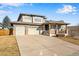 Two-story house with attached two-car garage and landscaped front yard at 13676 Cherry Way, Thornton, CO 80602