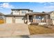 Two-story house with attached two-car garage and landscaped front yard at 13676 Cherry Way, Thornton, CO 80602