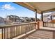 Covered front porch with brick columns and view of the neighborhood at 13676 Cherry Way, Thornton, CO 80602