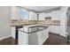 Spacious kitchen with white cabinets, granite countertops, and an island at 13676 Cherry Way, Thornton, CO 80602