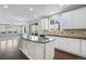 Kitchen with white cabinets, granite countertops and an island at 13676 Cherry Way, Thornton, CO 80602