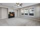 Living room featuring a fireplace and large windows at 13676 Cherry Way, Thornton, CO 80602