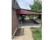 Covered patio area with brick exterior and view of the backyard at 8250 Ralph Ln, Denver, CO 80221